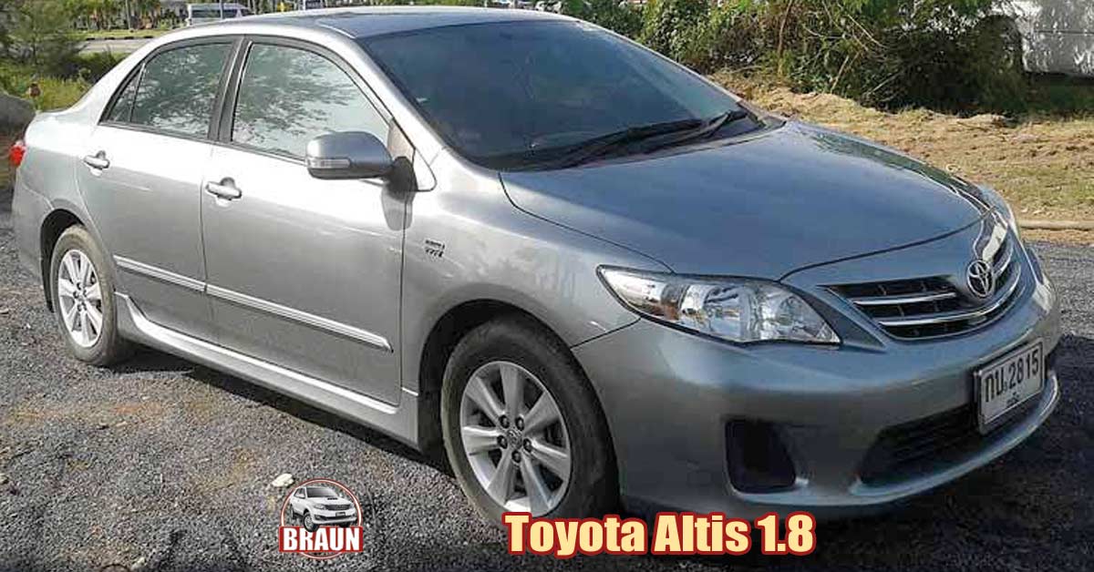 silver grey toyota altis 1.8 litre saloon / sedan rental car in phuket on a quiet residential and rural road