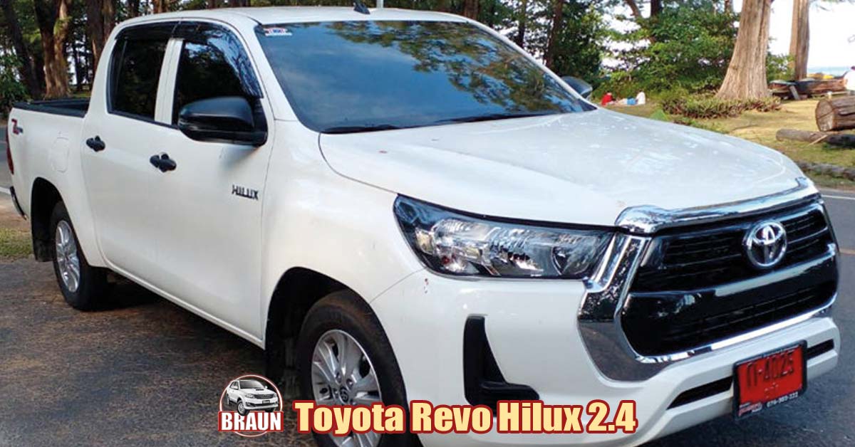 white toyota revo hilux 2.4 litre parked beachside in phuket with a family enjoying a picnic in a wooded area on the coast