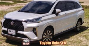 white toyota veloz hire car parked at the edge of a beach on seagrass and sand in phuket